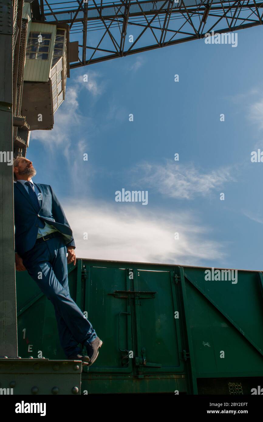 best ager posing on a steel construction Stock Photo Alamy