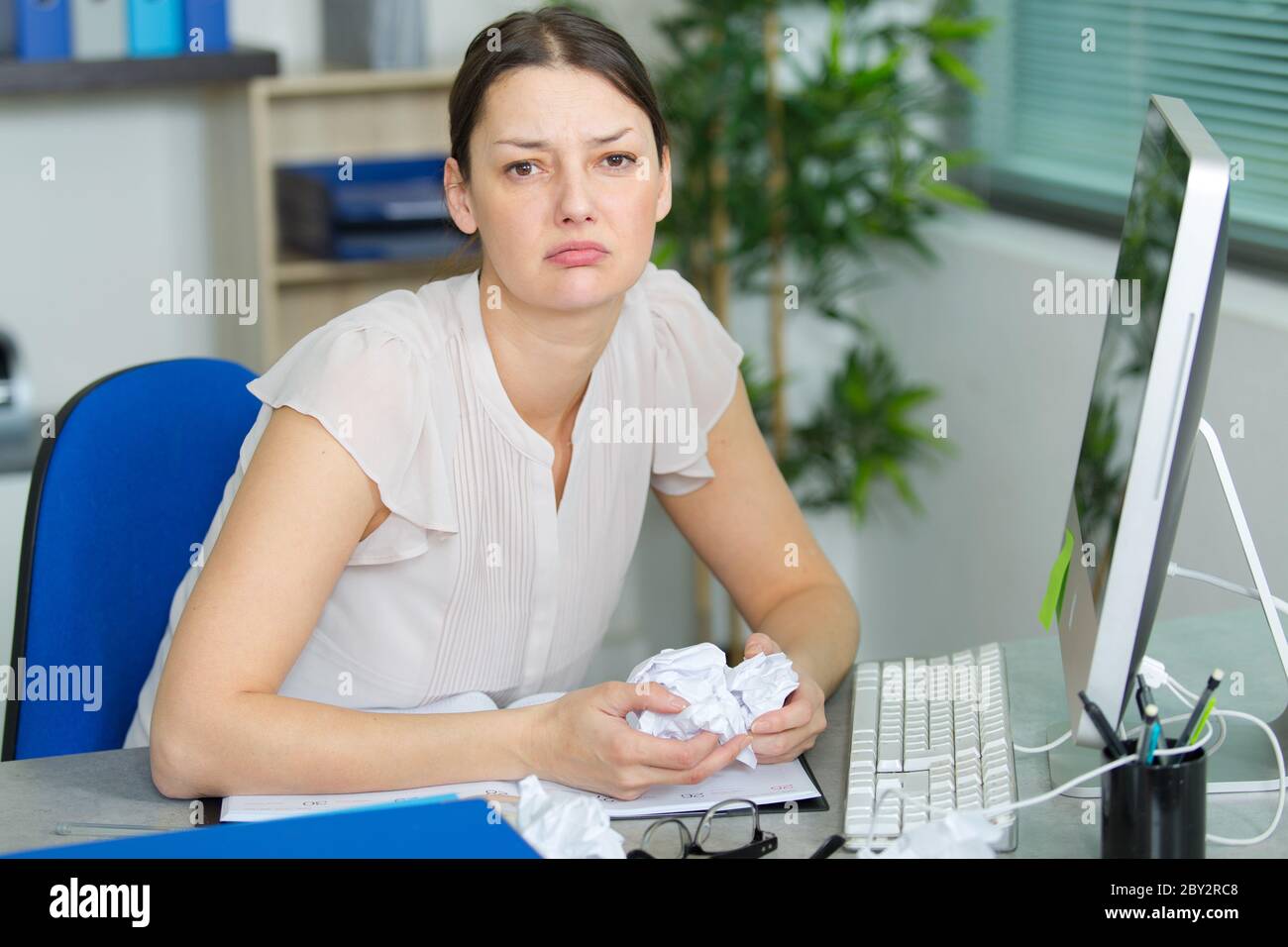 stressed businesswoman sitting in office Stock Photo