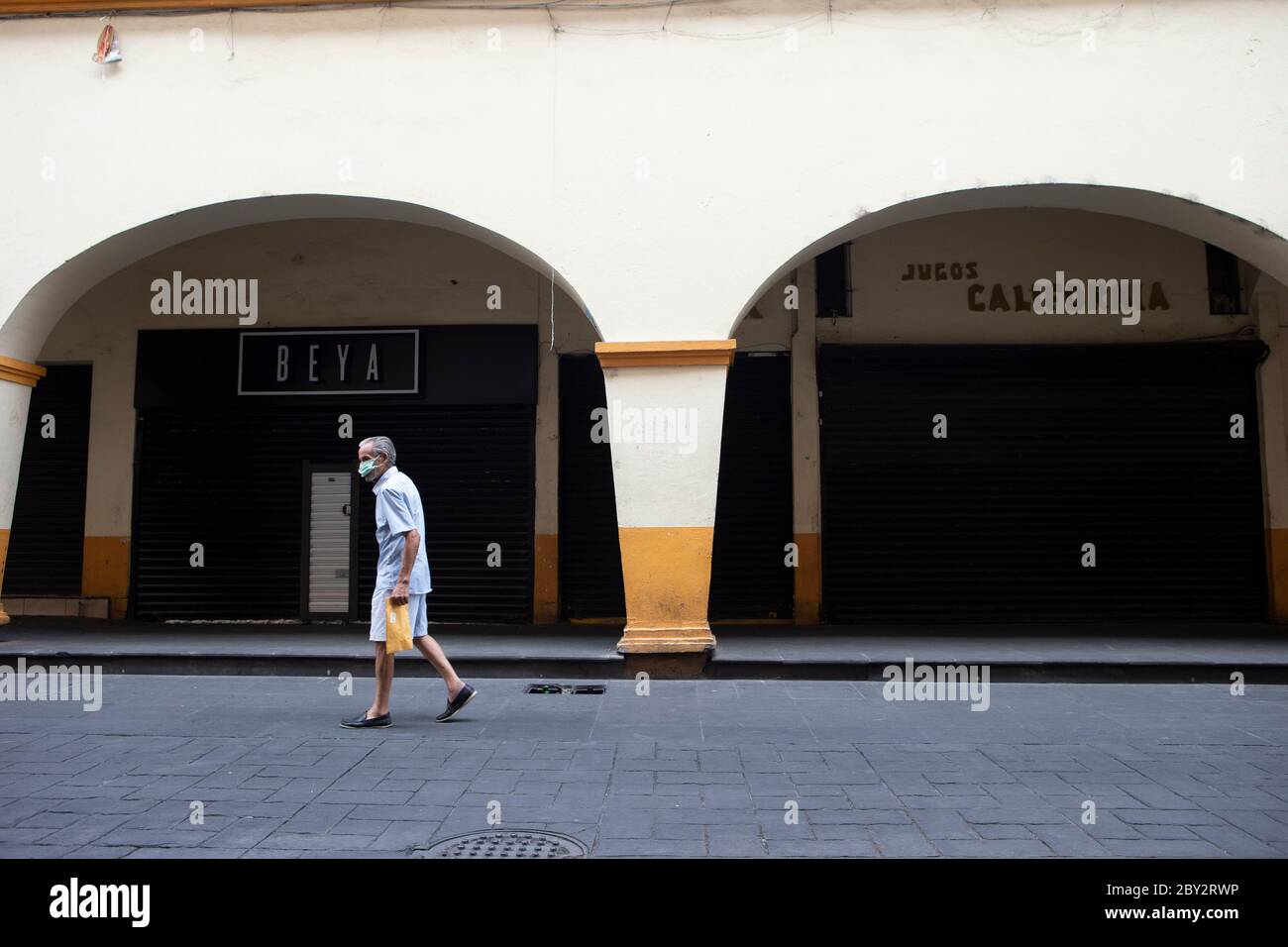 Cuernavaca, Mexico. 8th June, 2020. A man wearing a face mask walks along a street in the center of Cuernavaca, Mexico, on June 8, 2020. Credit: Marco Diaz/Xinhua/Alamy Live News Stock Photo