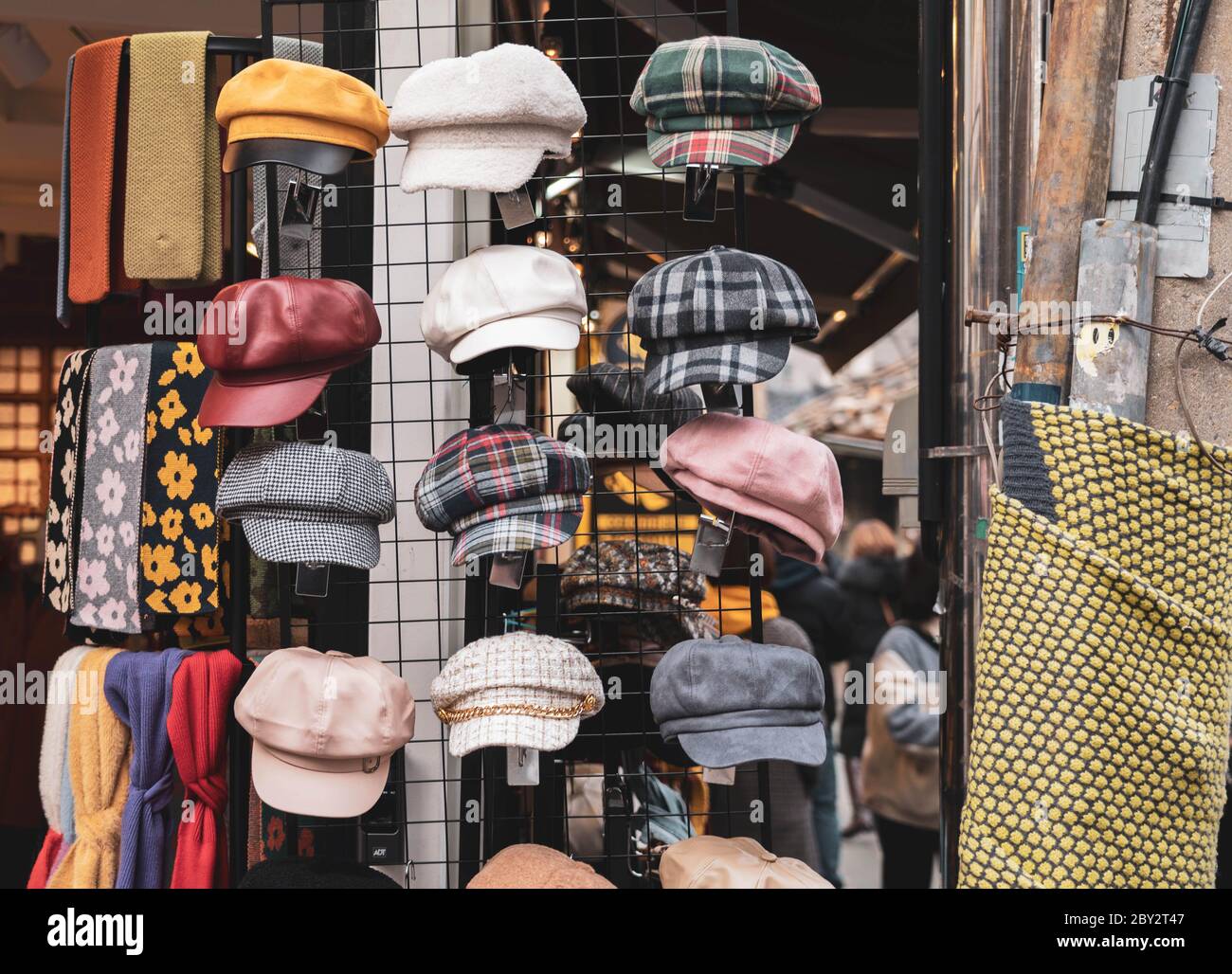 Various women stylish hat displayed outside the store. Vintage autumn fashion beret cap with unique design. Stock Photo