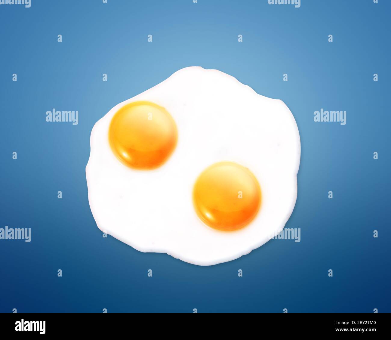 Fried egg on Blue background Stock Photo