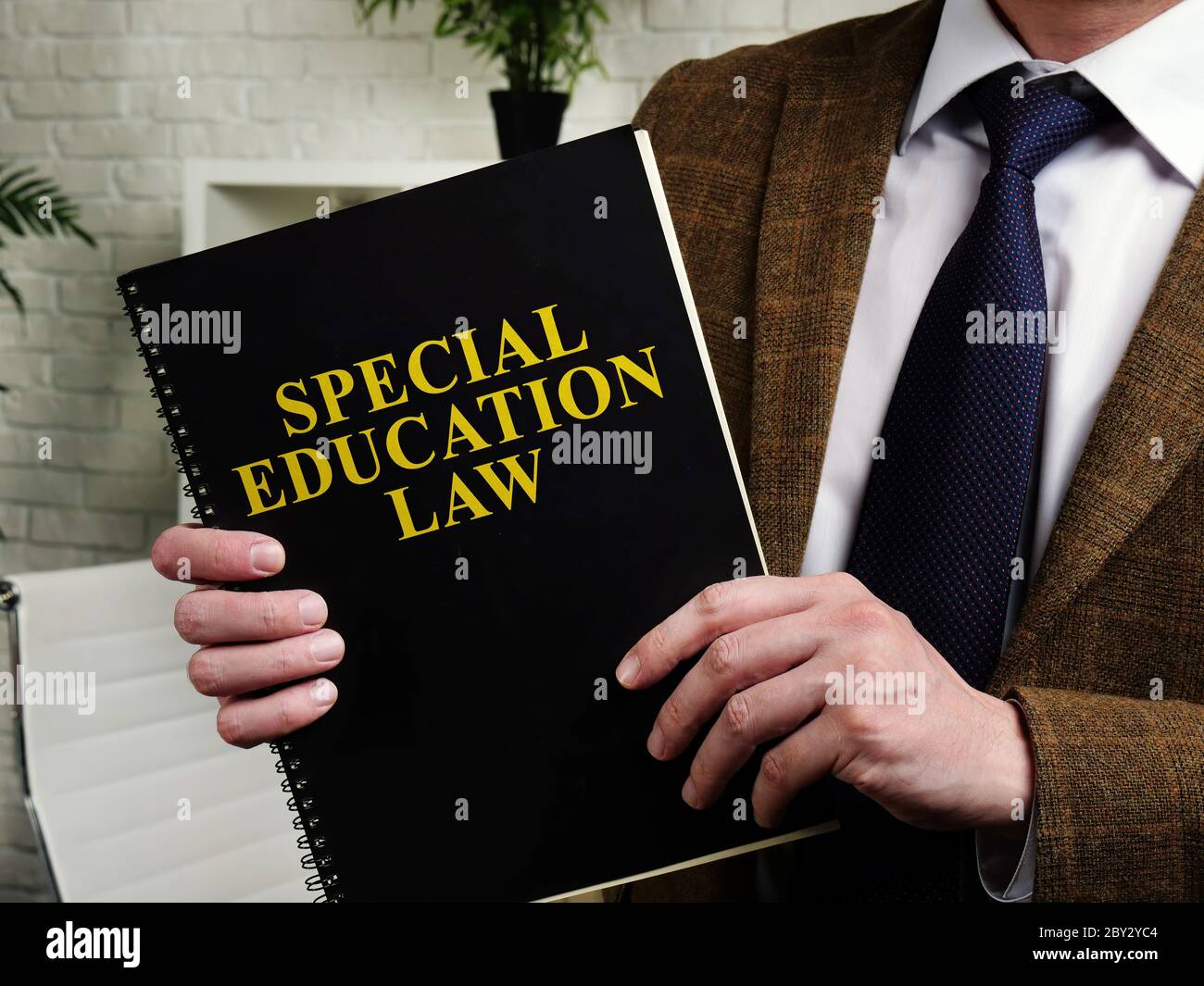 Man in suit holds Special Education Law. Stock Photo