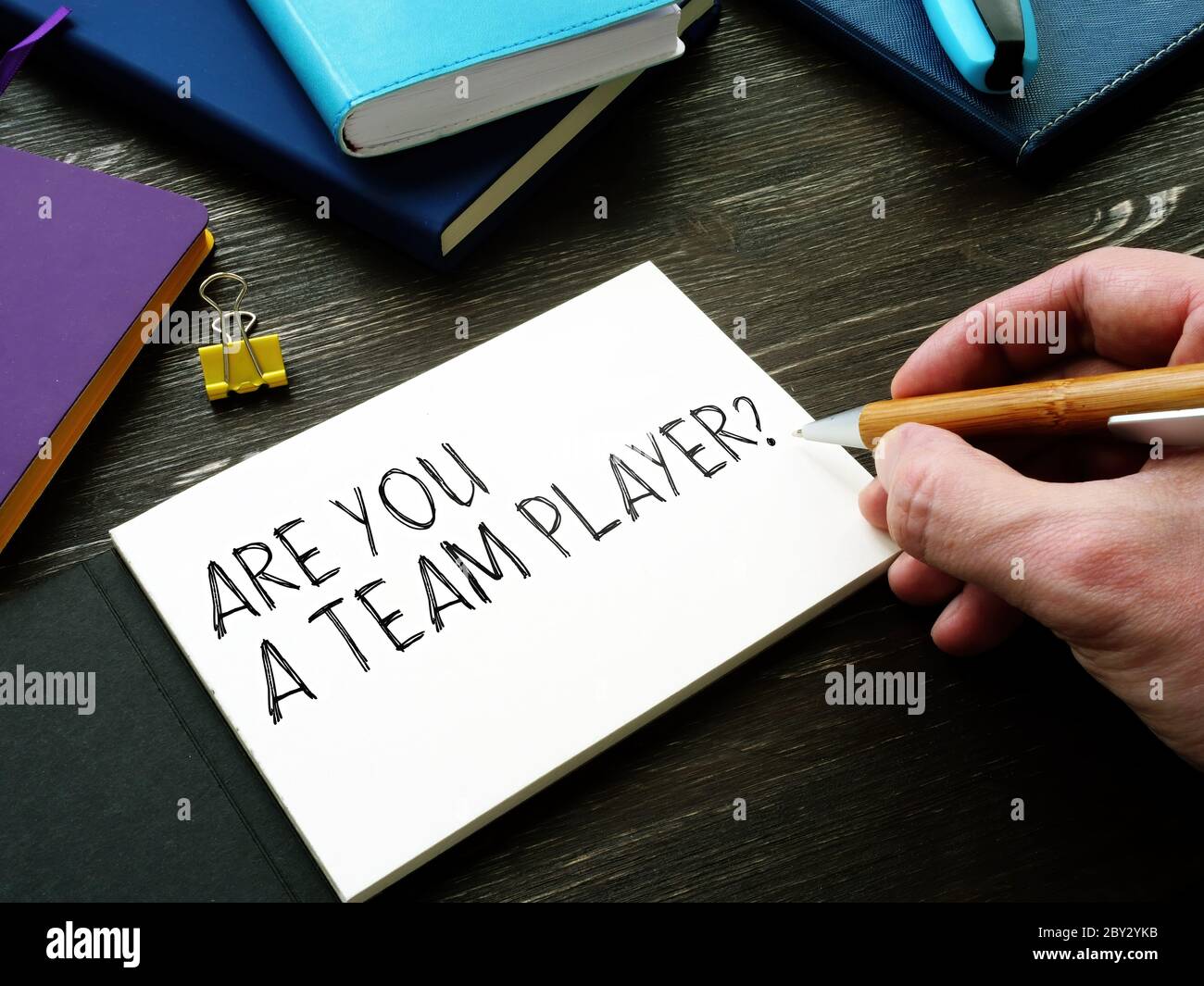 Man writes Are You a Team Player question. Teamwork concept. Stock Photo