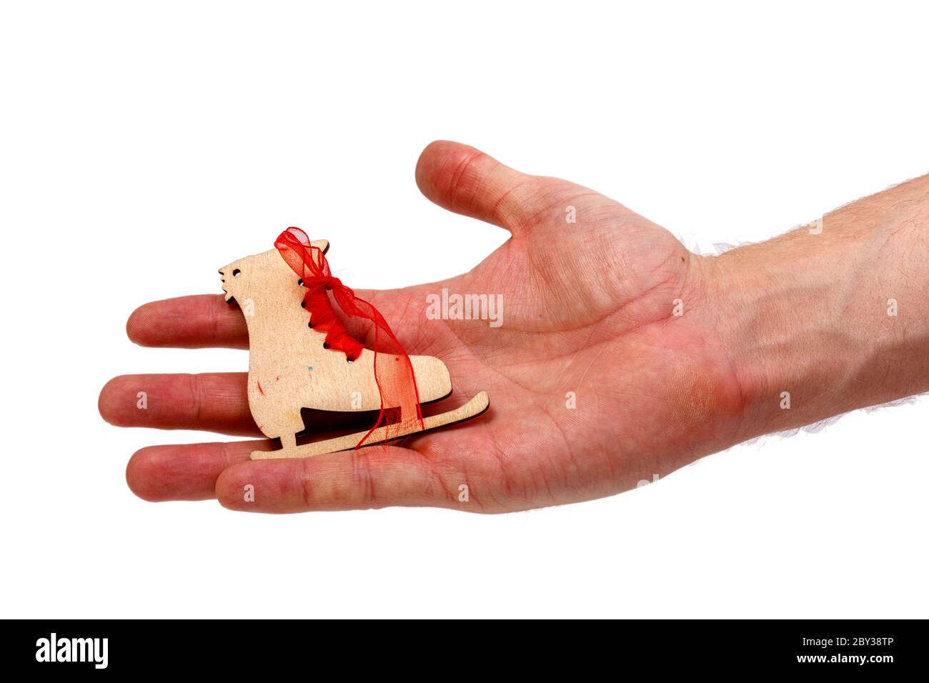 Male Hand Holding Wooden Ice Skate Isolated On White Background