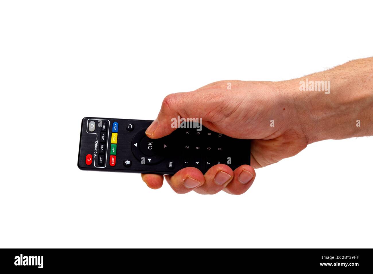 Male hand holding tv remote isolated on white background. Minimalistic concept. Stock Photo