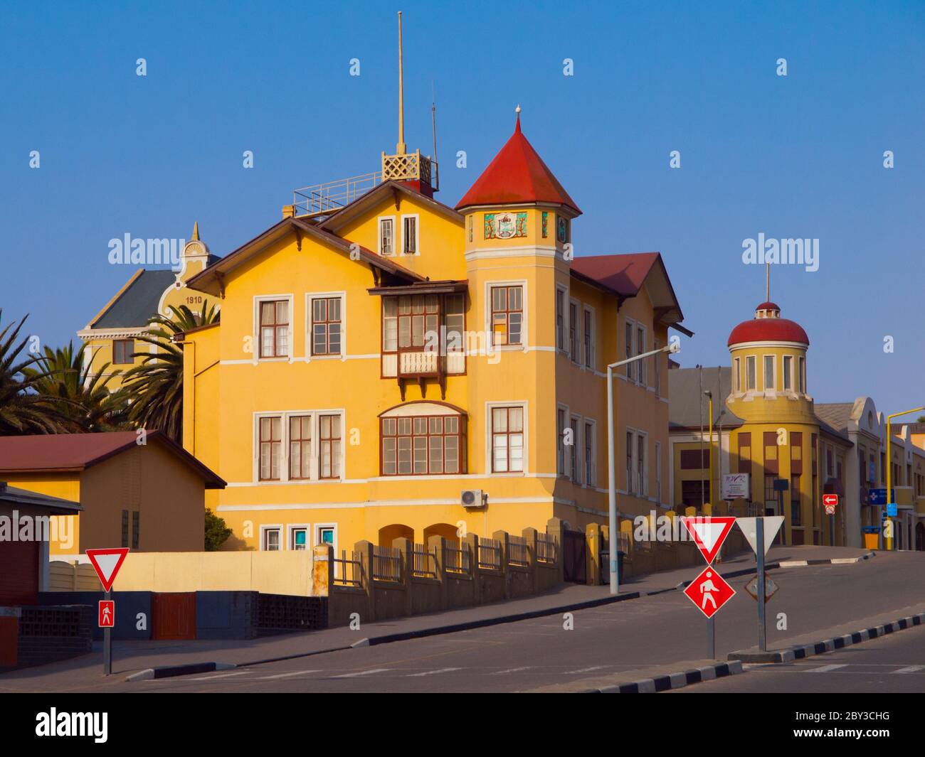 Typical house with vivid yellow facade - german colonial architecture, Swakopmund, Namibia Stock Photo