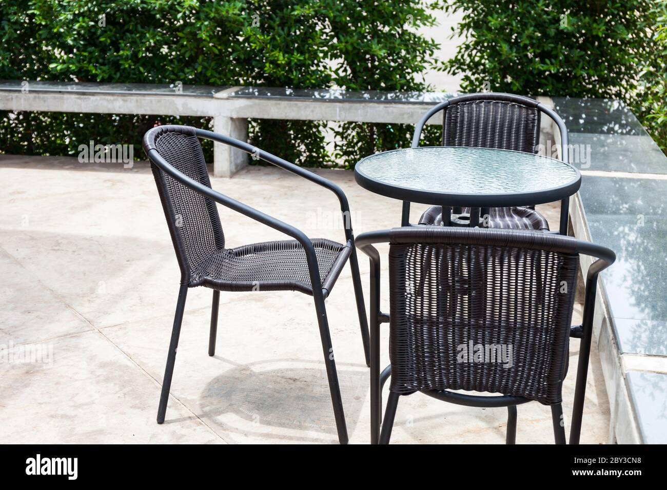 Striped table and wicker armchairs. Outdoors Stock Photo - Alamy
