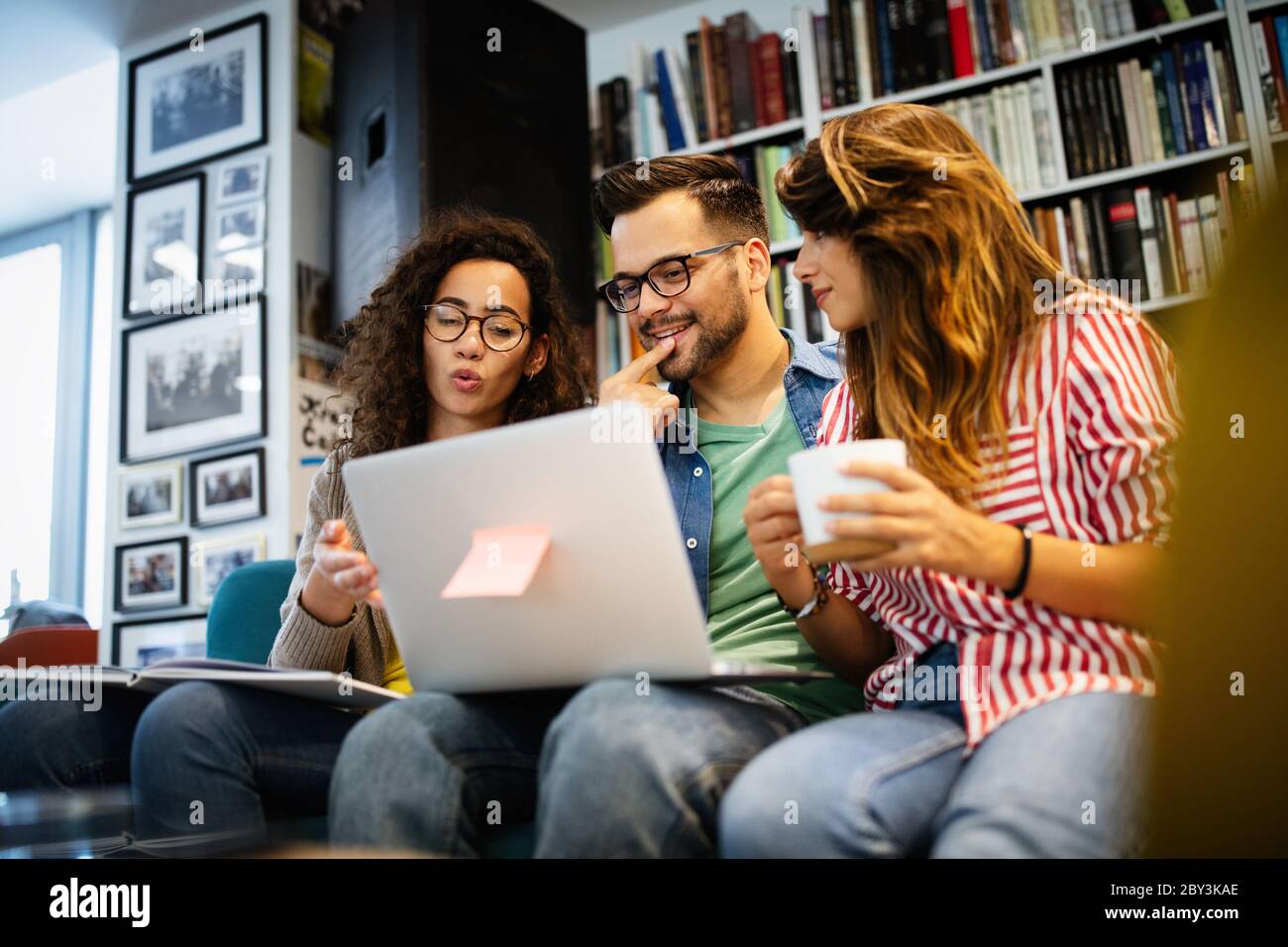 Group of college students studying in the school library. Stock Photo