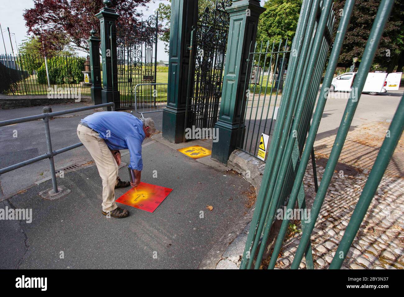 Carmarthen, UK. 9 June, 2020. Adrian Lloyd, Operations Officer for Carmarthen Town Council, prepares to re-open Carmarthen Park by stencilling signs encouraging social distancing at the entrances to the Park. The park has been closed since Lockdown was imposed on the 23rd March 2020. Credit: Gruffydd Ll. Thomas/Alamy Live News Stock Photo