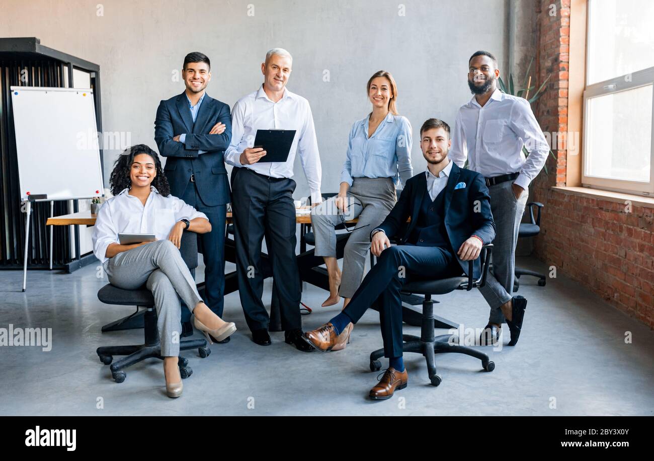 Coworkers Smiling To Camera Posing In Modern Office Stock Photo - Alamy