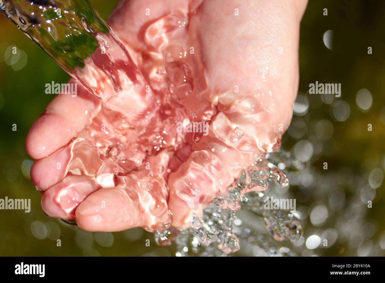 natural spring water in the hands Stock Photo Alamy