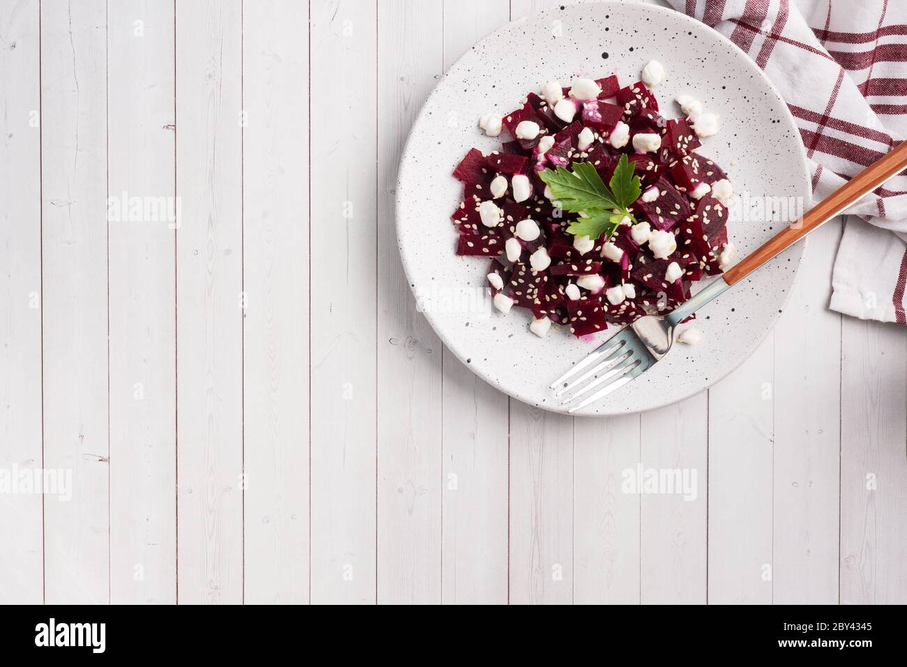 Salad of boiled beetroot and grain curd with sesame seeds on a plate Copy space Stock Photo