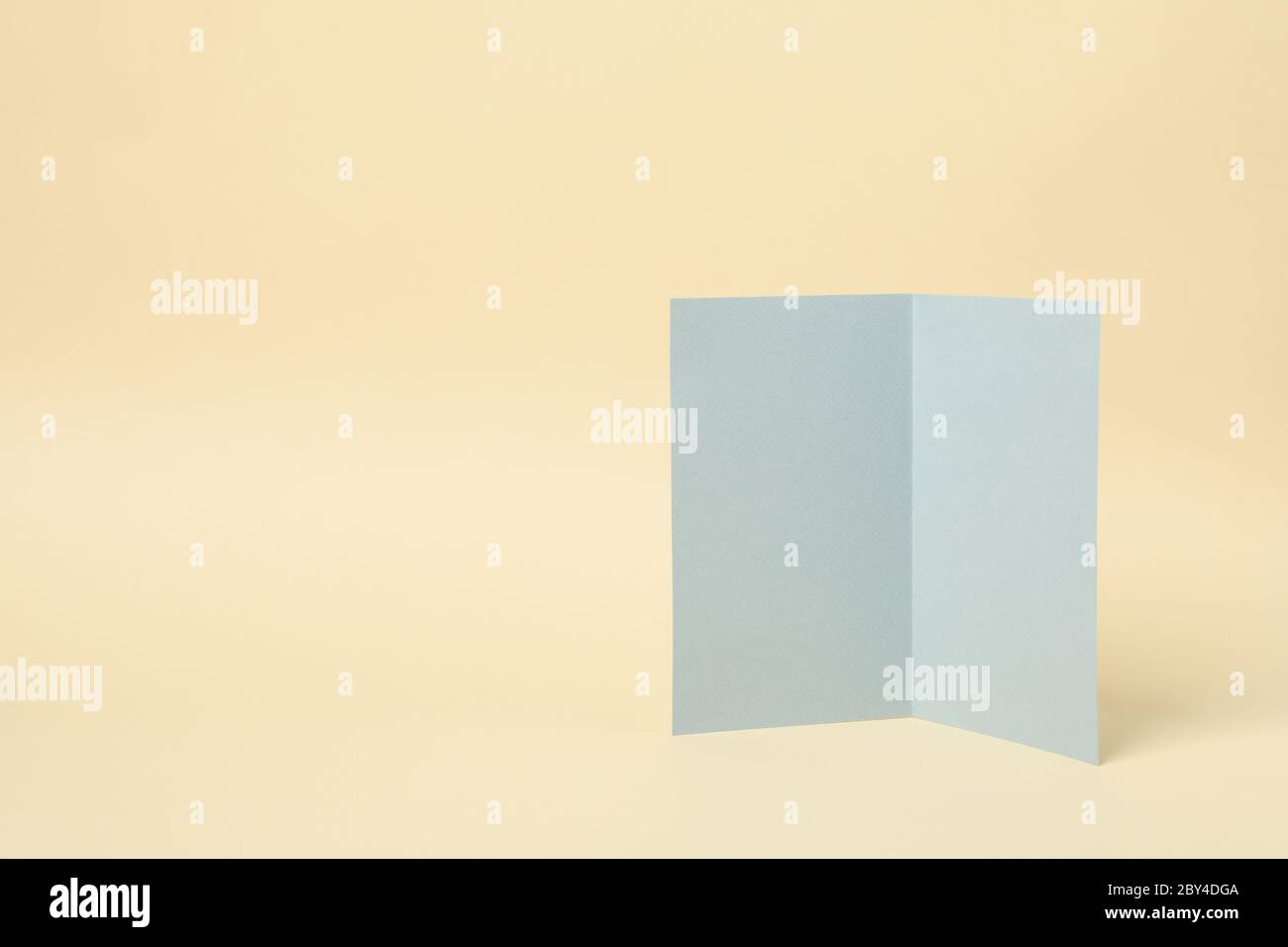 Light gray cardboard on beige background, space for text Stock Photo