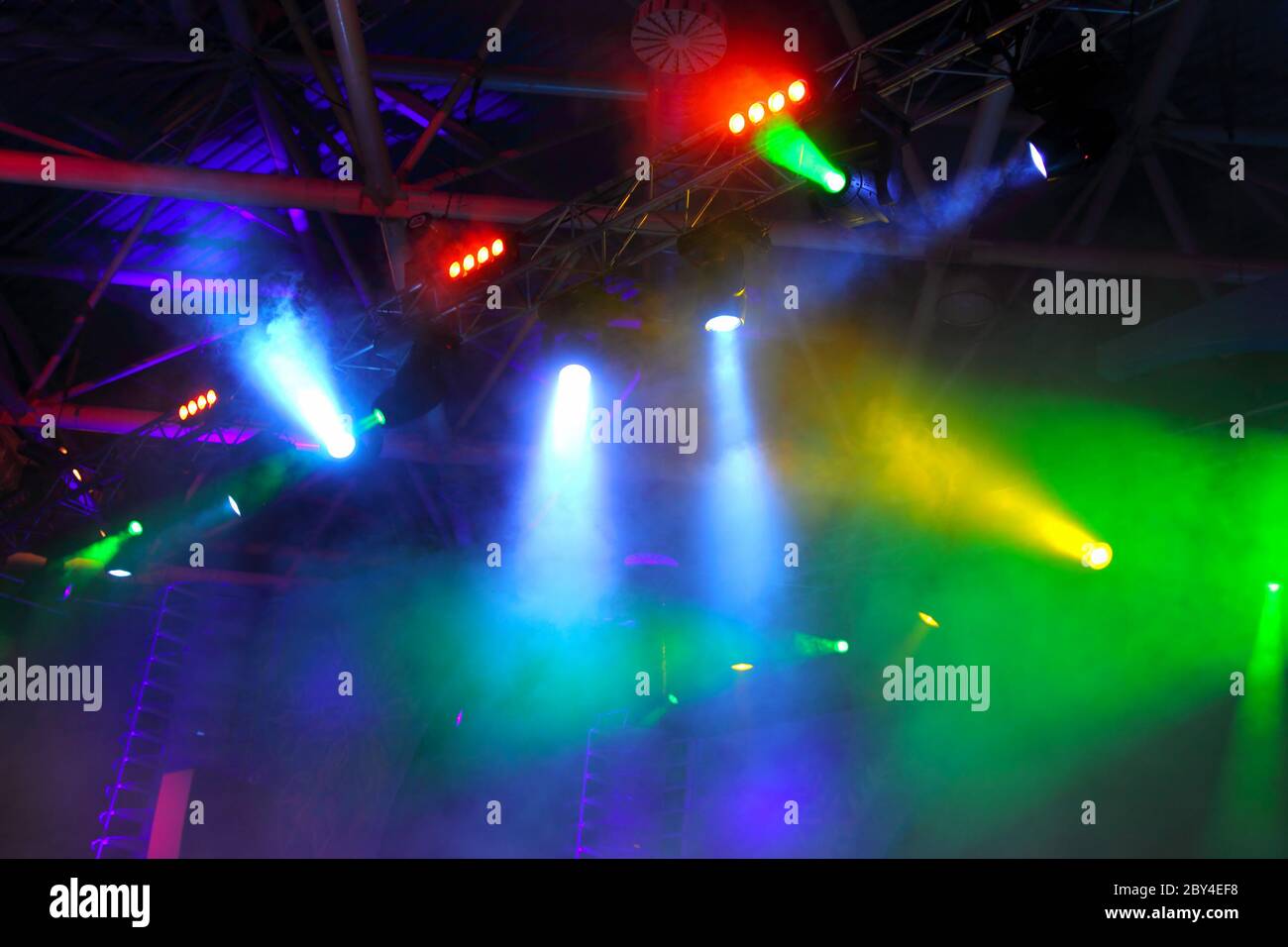 colored spotlights on ceiling in smoke Stock Photo