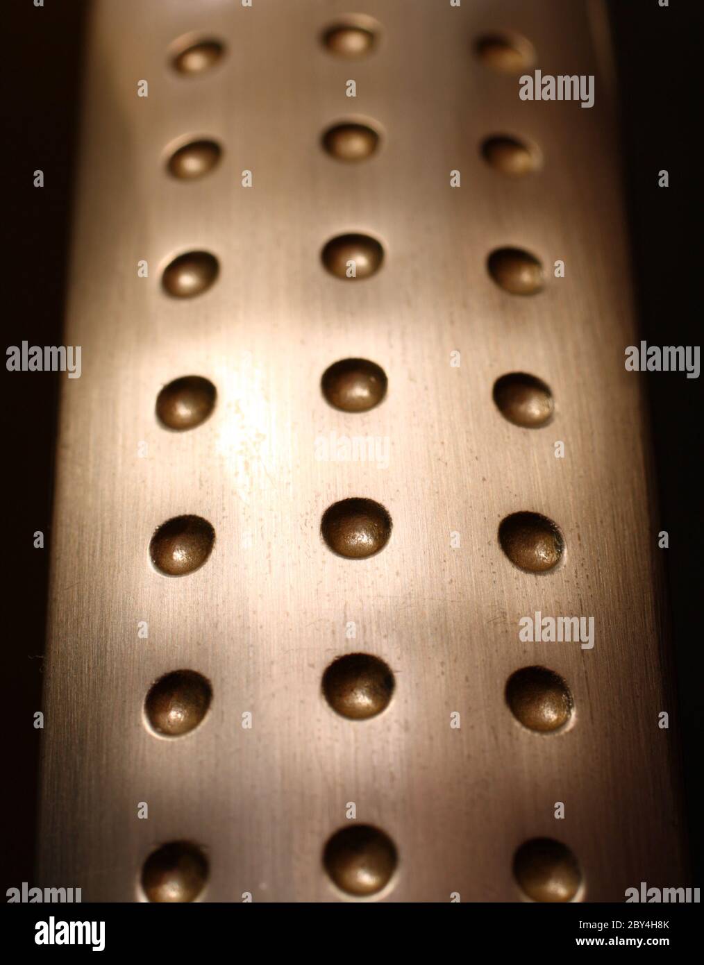 spherical metal surface background with holes Stock Photo