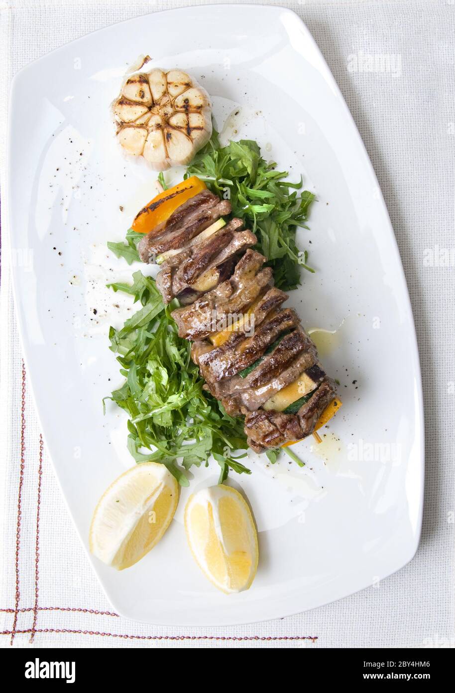 shashlik with potherbs on the plate shashlik with potherbs on the plate Stock Photo