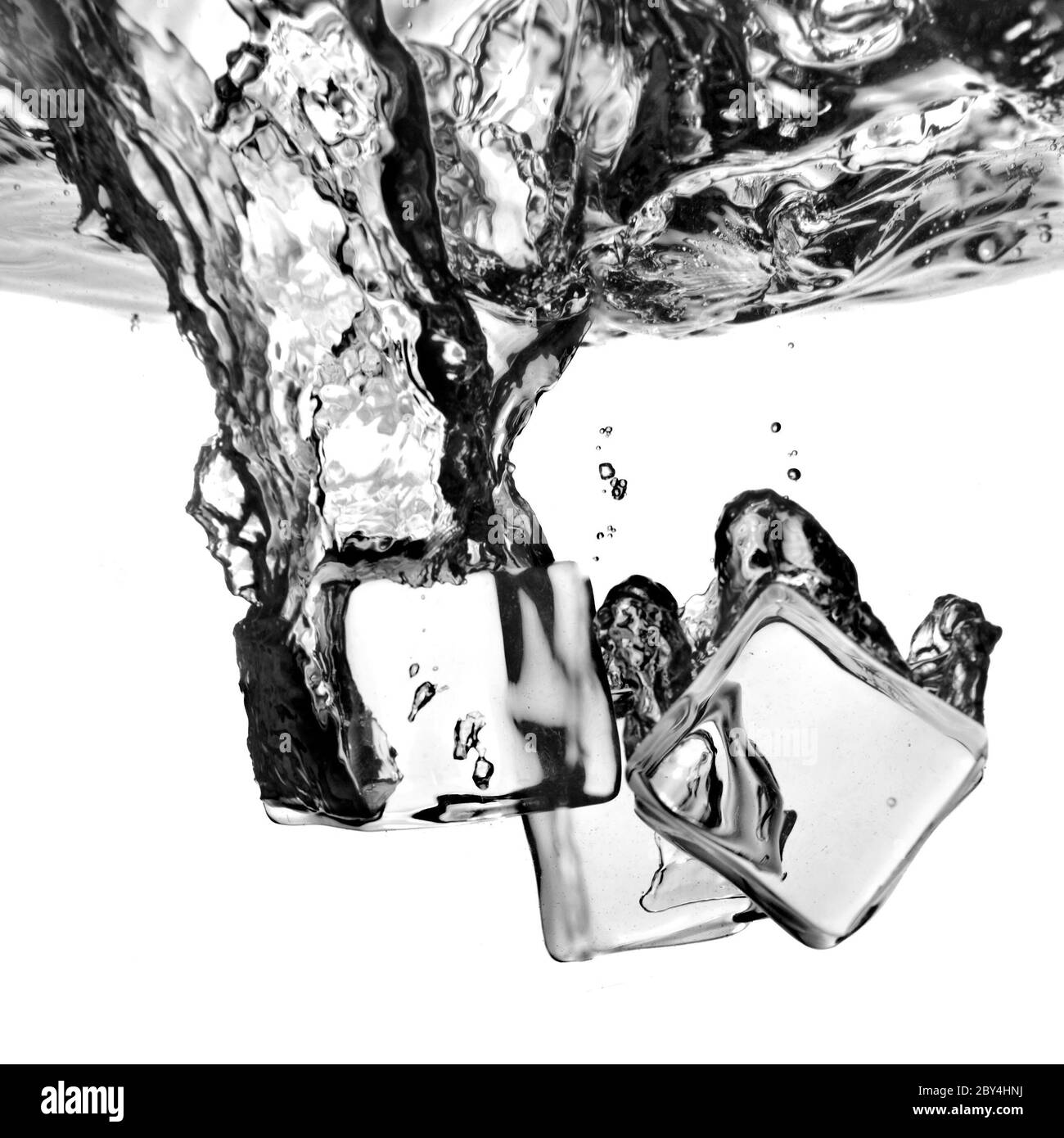 ice cubes dropped into water with splash isolated on white Stock Photo ...