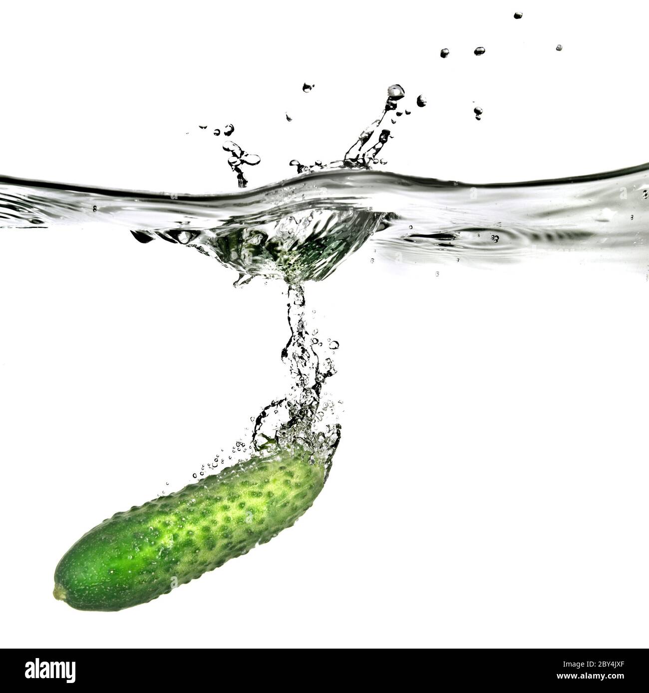 green cucumber dropped into water isolated on white Stock Photo Alamy