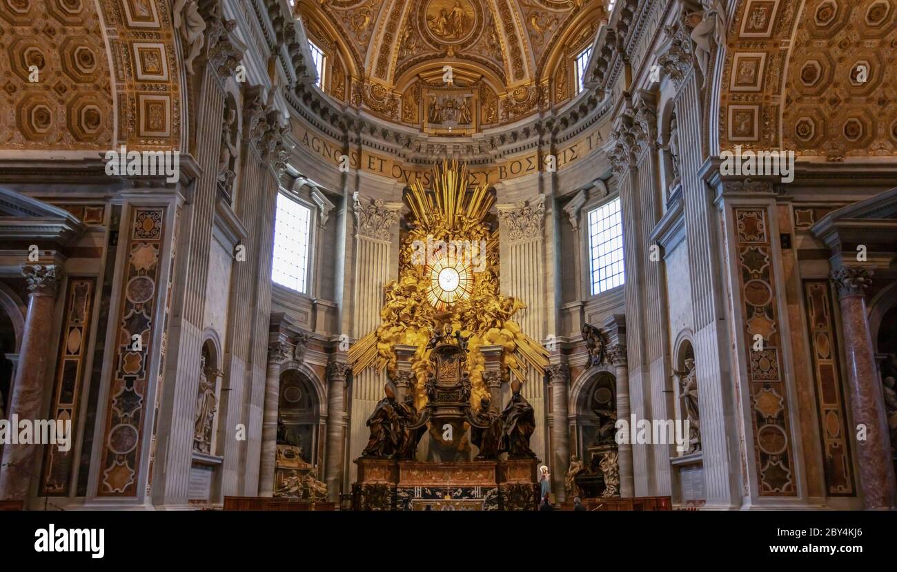 A view towards the altar and papal chair in the apse of St Peter's Basilica, Vatican City. Stock Photo