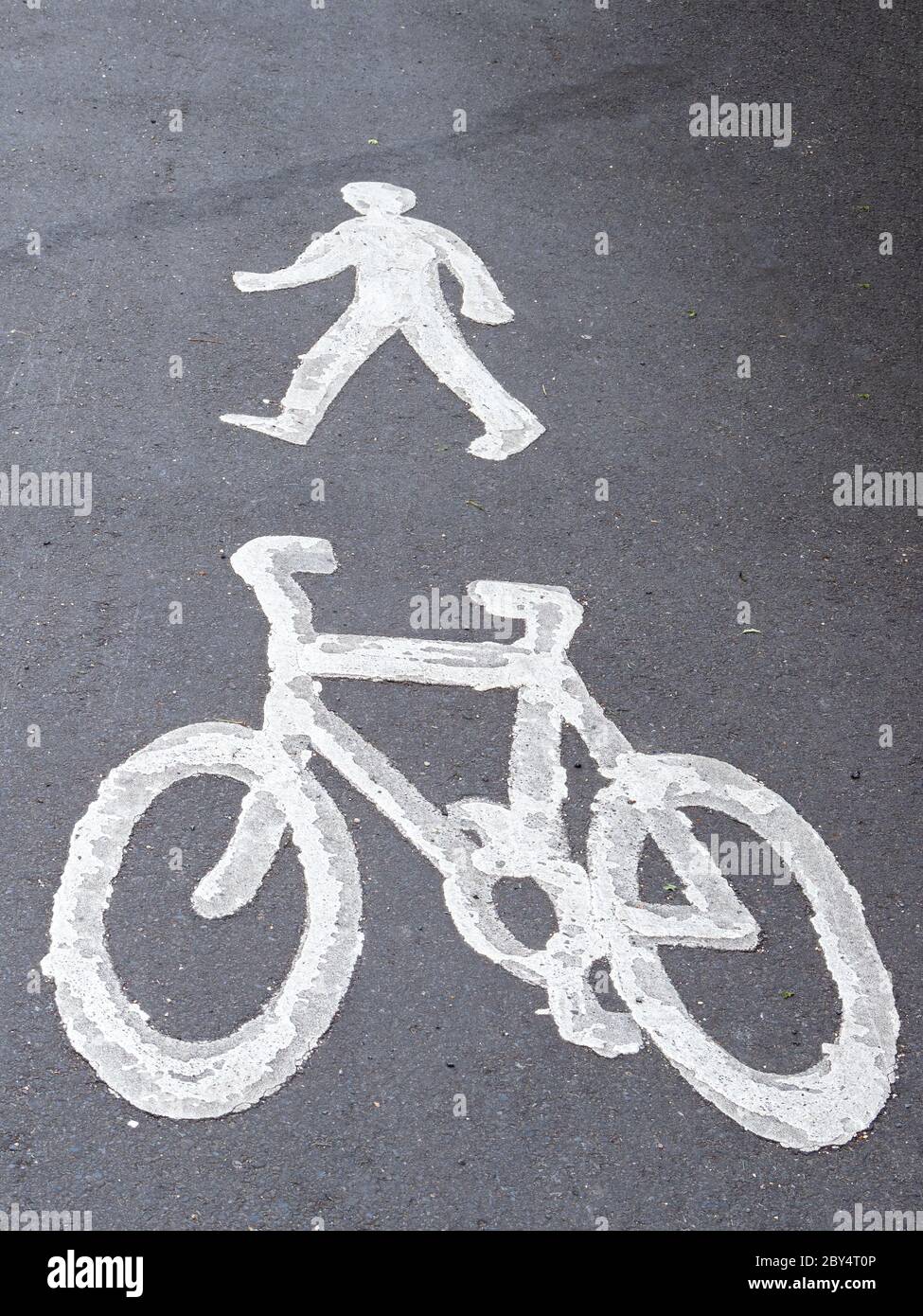 Pavement, sidewalk signs for cyclists and pedestrians. Cycle path, route. Bicycle and person. Stock Photo