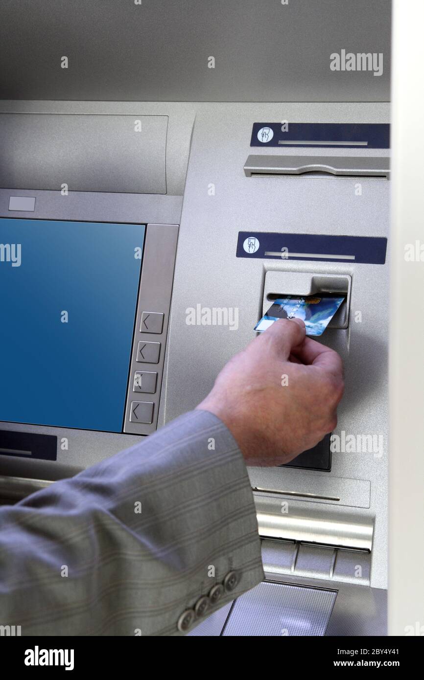 hand inserting card into cash dispense Stock Photo Alamy