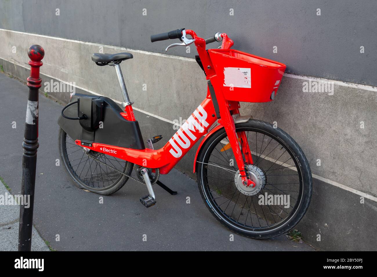 Jump red shared electric bicycle parked in a street in Paris, France. Jump is owned by Uber Stock Photo