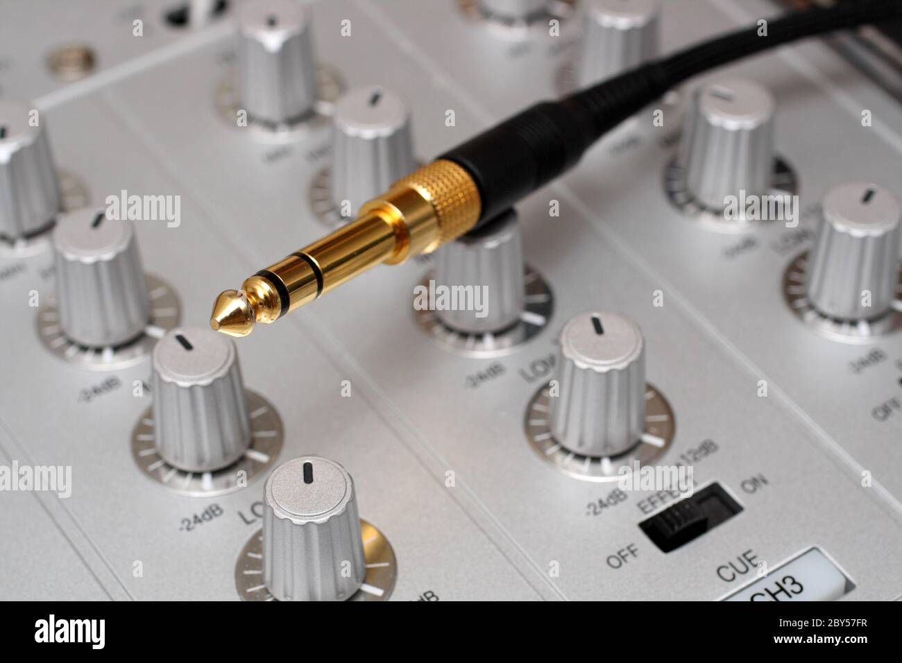 gold plug on dj music mixer Stock Photo Alamy