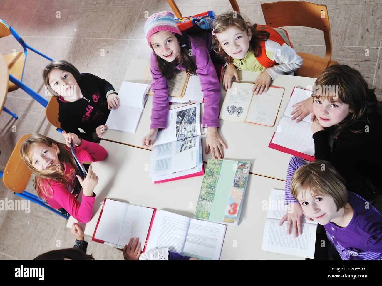 happy kids with teacher in school classroom Stock Photo - Alamy