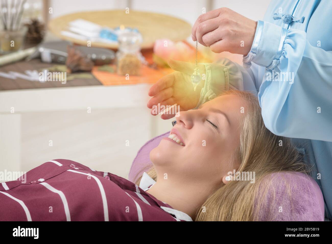 Alternative medicine therapist using pendulum to make a diagnosis Stock