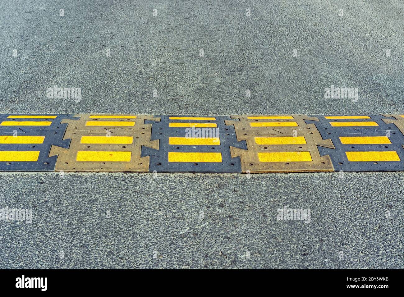 Speed bump installed on the road in front of a pedestrian crossing
