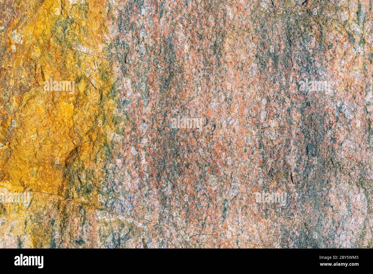 Fragment of the rough surface of a flat stone. For use as an abstract background. Stock Photo