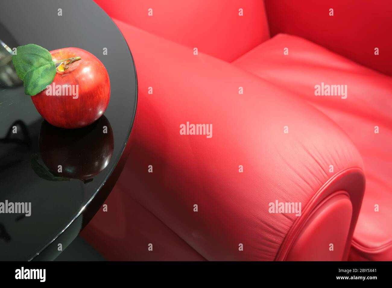 red apple and a red easy chair Stock Photo