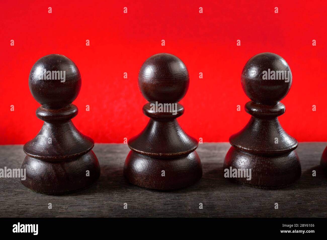 Macro Selective Focus Photo of Black Chess Figures on Red  Color Background Stock Photo