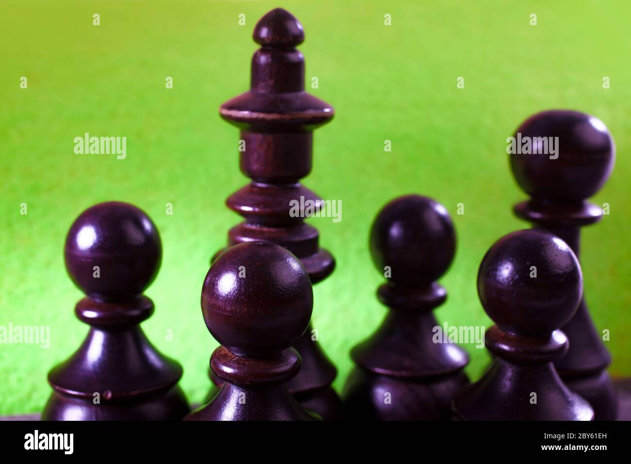 Macro Selective Focus Photo of Black Chess Figures on Green Color Background Stock Photo