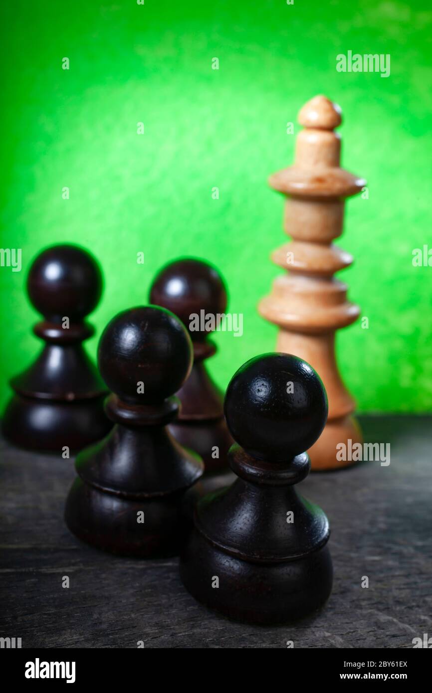 Macro Selective Focus Photo of Black Chess Figures on Green Color Background Stock Photo