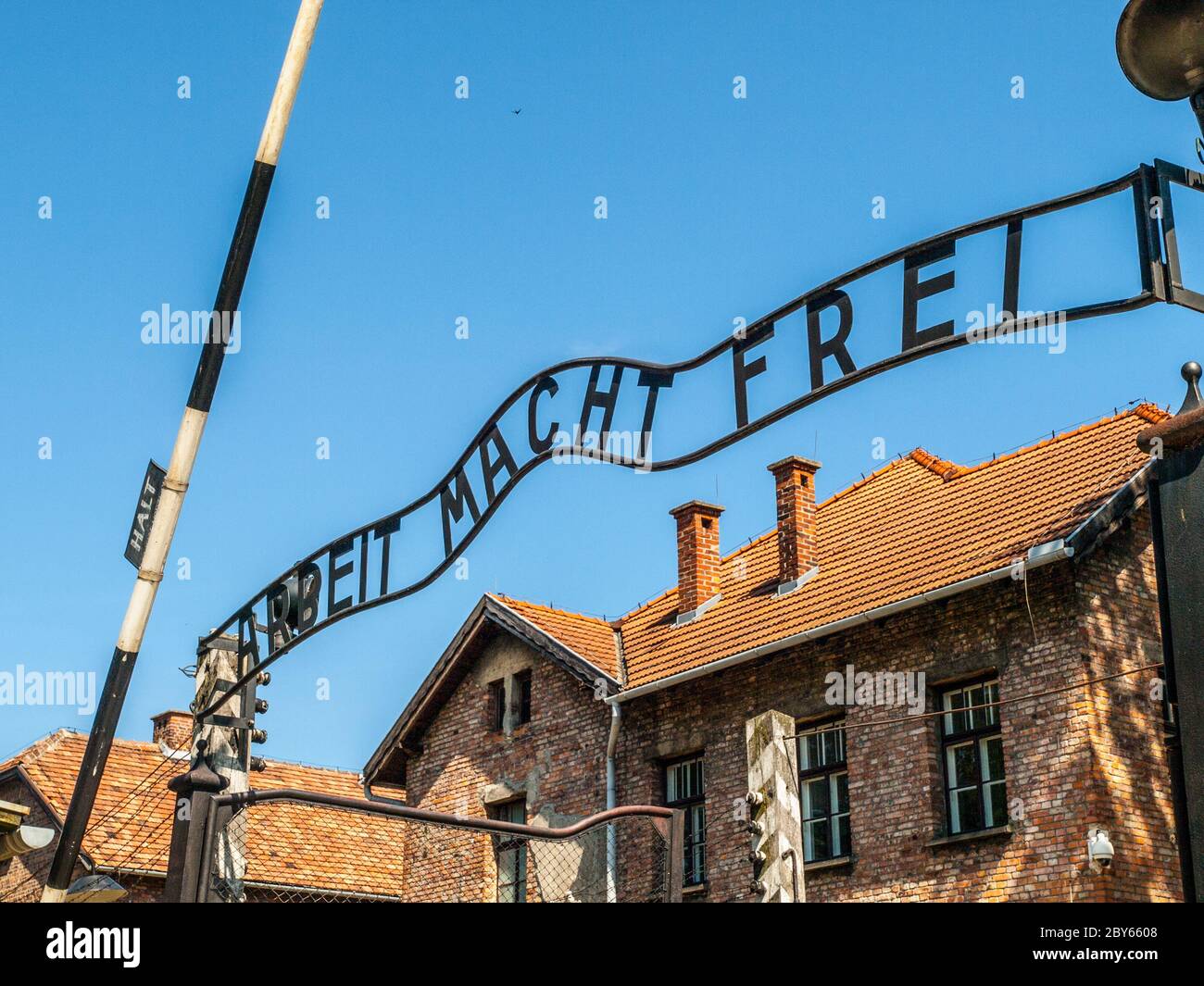 Metal inscription Arbeit macht frei on the main entrance gate to Oswiecim concentration camp, Poland. Stock Photo