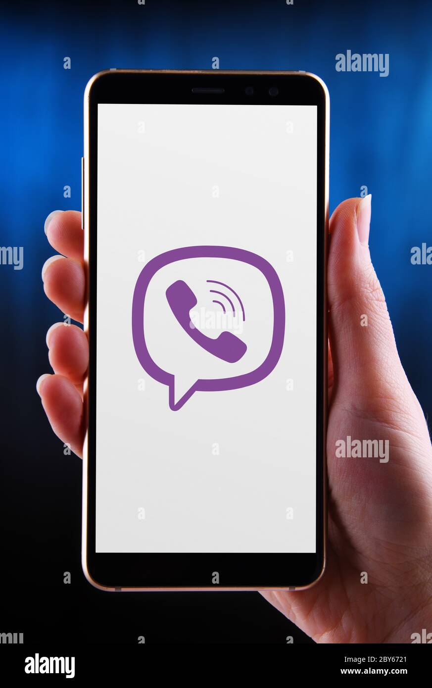 POZNAN, POL - MAY 21, 2020: Hands holding smartphone displaying logo of Viber, a cross-platform voice over IP and instant messaging software applicati Stock Photo