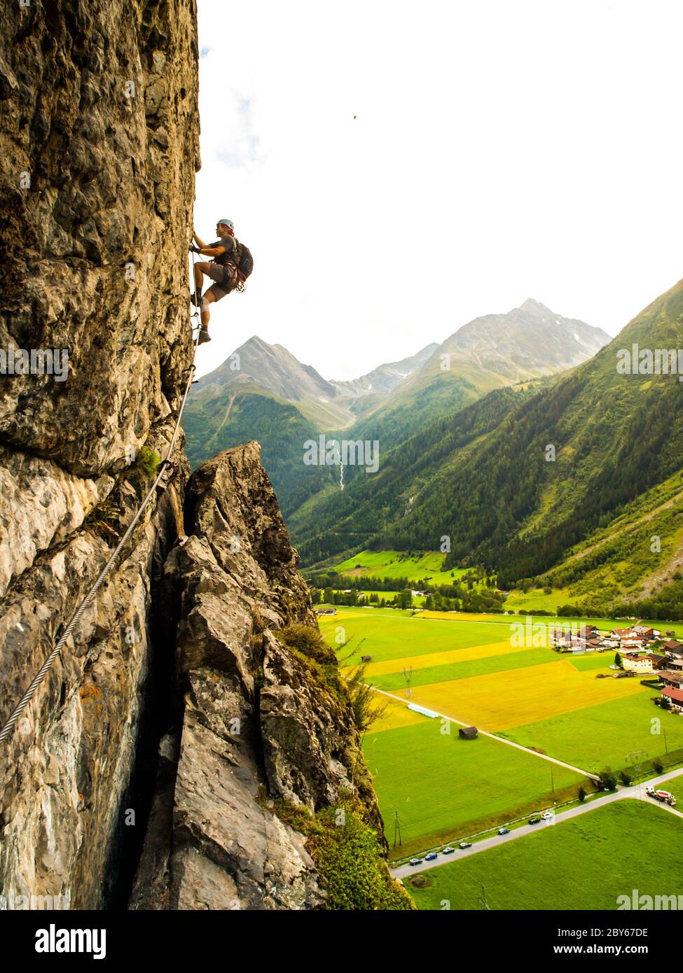 Via ferrata climber climbs vertical rock, Reinhard Schiestl Klettersteig, Austria Stock Photo