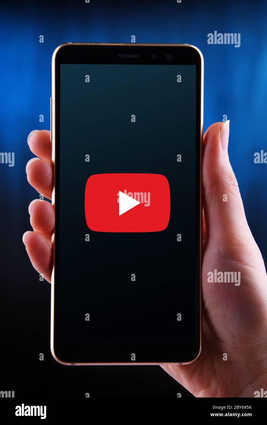 POZNAN, POL MAY 21, 2020 Hands holding smartphone displaying logo of