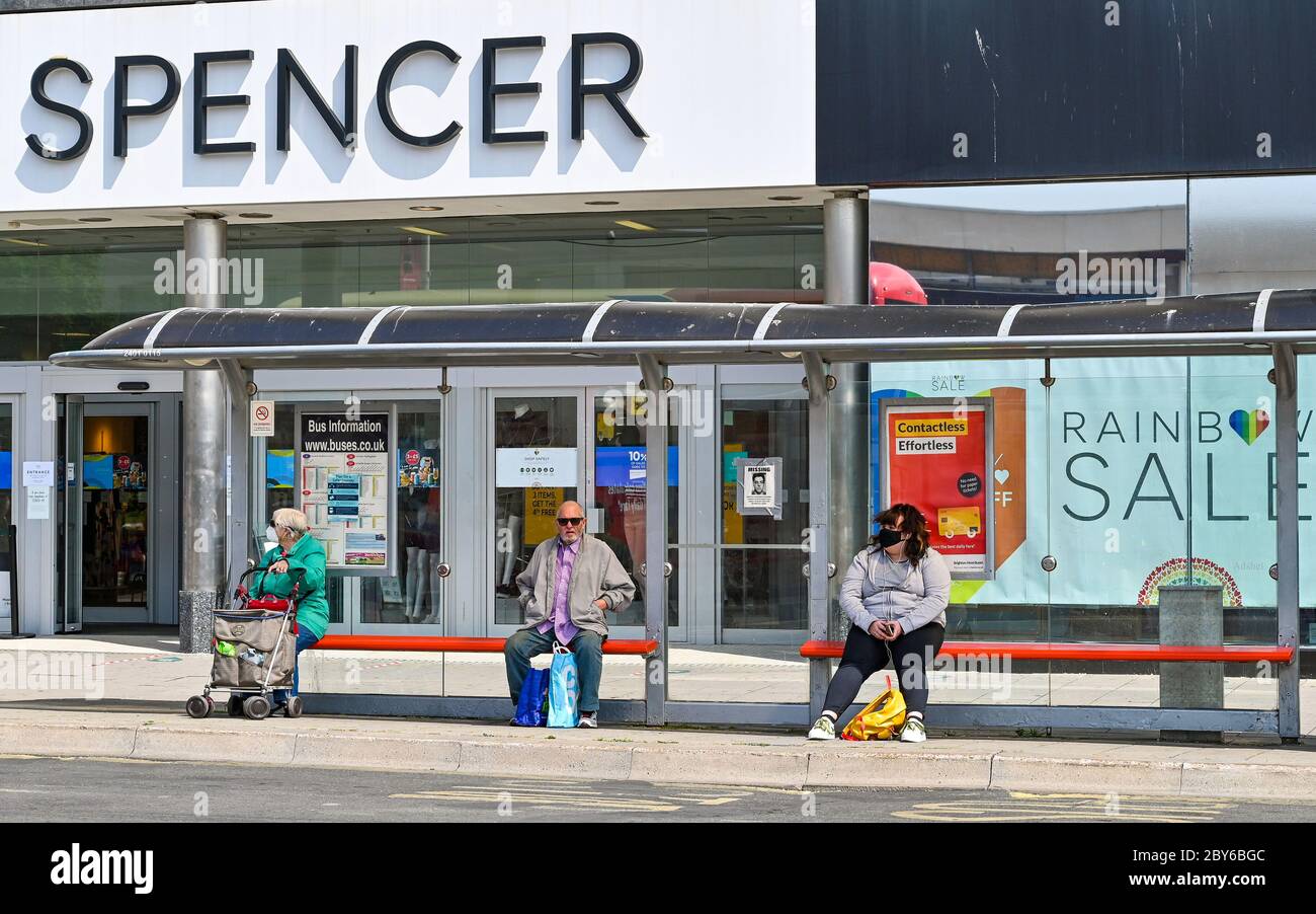 Brighton UK 9th June 2020 - Shoppers at a bus stop in Brighton as more non essential shops and cafes prepare to reopen during easing of lockdown restrictions in the Coronavirus COVID-19 pandemic crisis  . Credit: Simon Dack / Alamy Live News Stock Photo