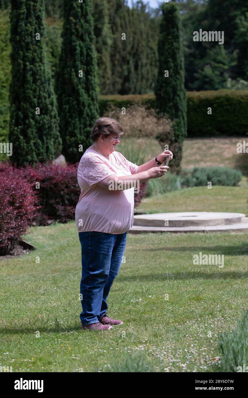Farnborough, Kent,9th June 2020,A lady takes a photo of the gardens