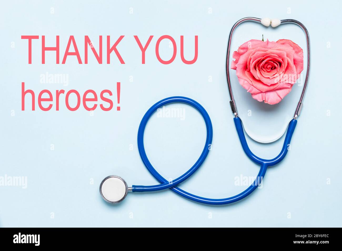 Thank you to healthcare heroes Covid-19 pandemic poster. Stethoscope and beautiful rose heart. Thanks to doctors, nurses, hospital workers. Stock Photo
