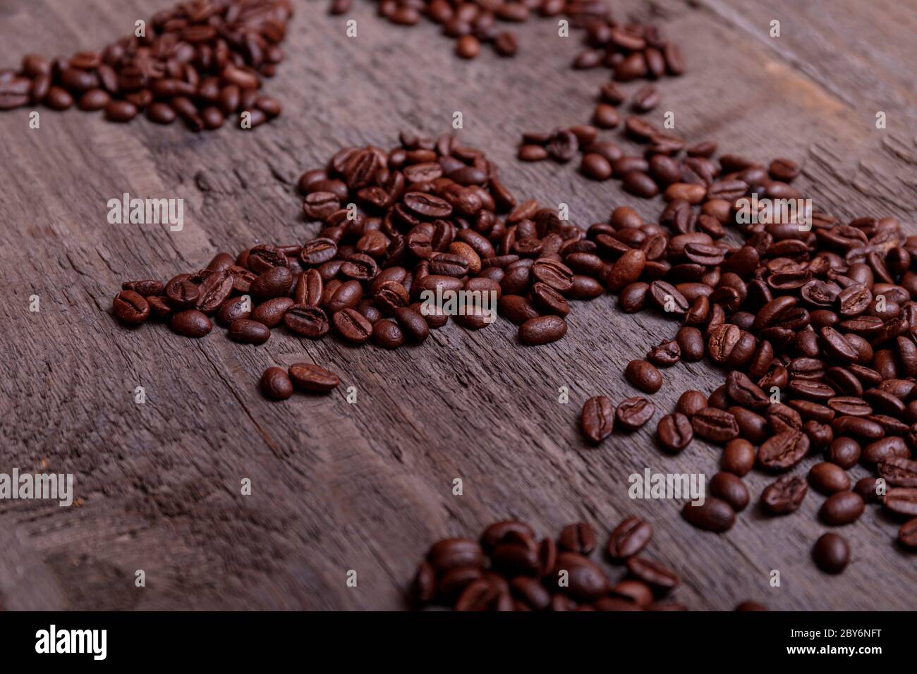 Dramatic photo of world map made of arabic roasted coffee beans on old vintage wooden table. Stock Photo