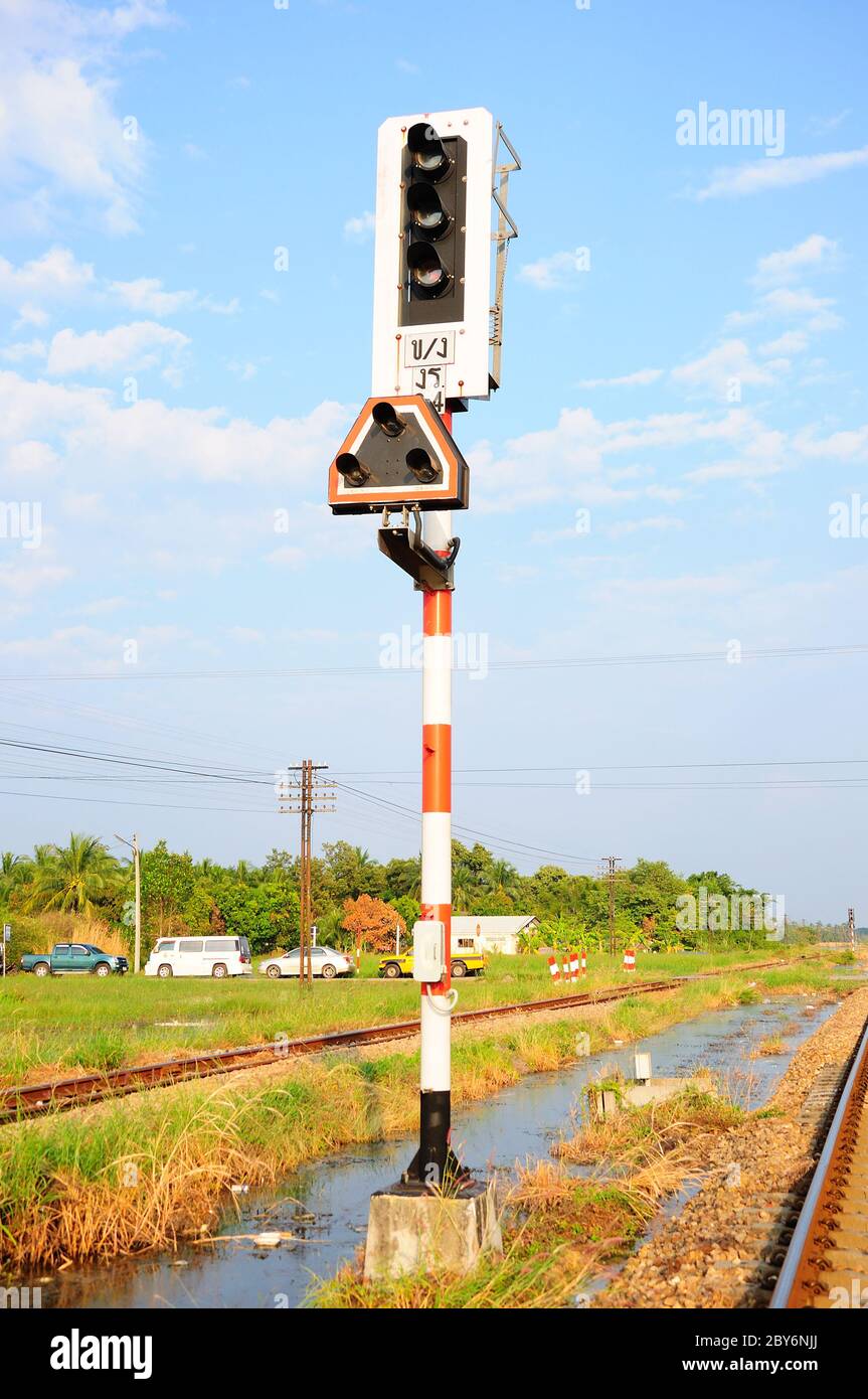 Traffic light shows red signal on railway. Railway station Stock Photo