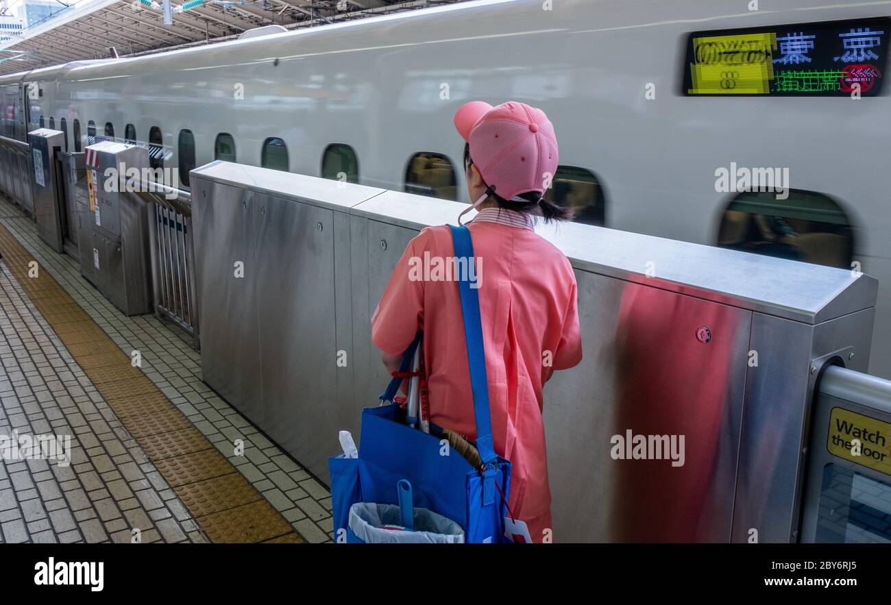 Cleaner worker in uniform at Tokyo Railway Station platform, Tokyo, Japan Stock Photo