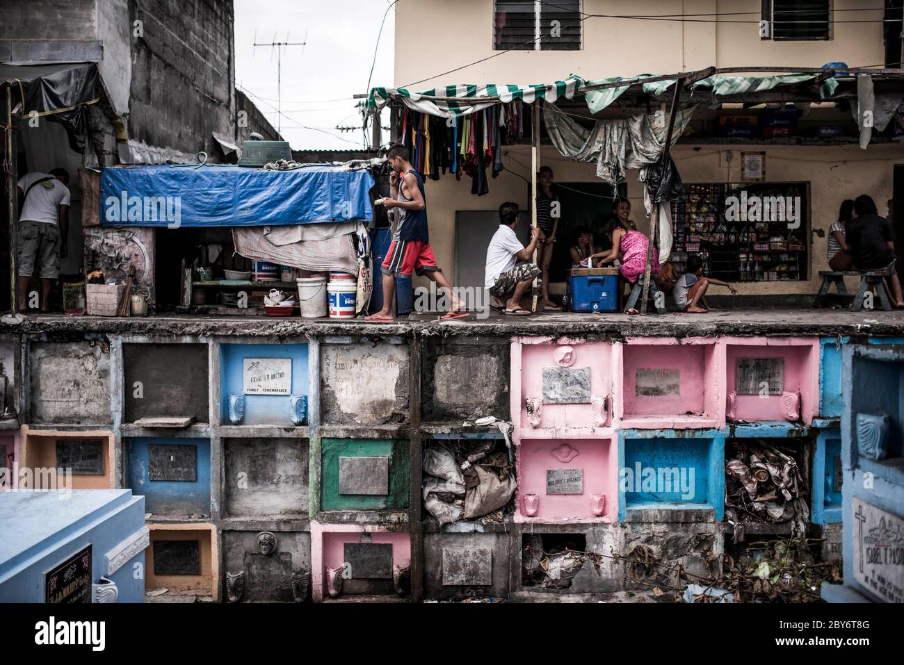 Some teenagers hang out between graves at Manila North cemetery in