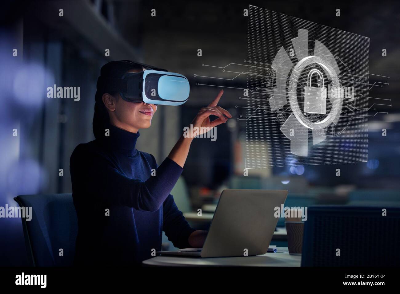 Businesswoman using virtual reality glasses at laptop Stock Photo