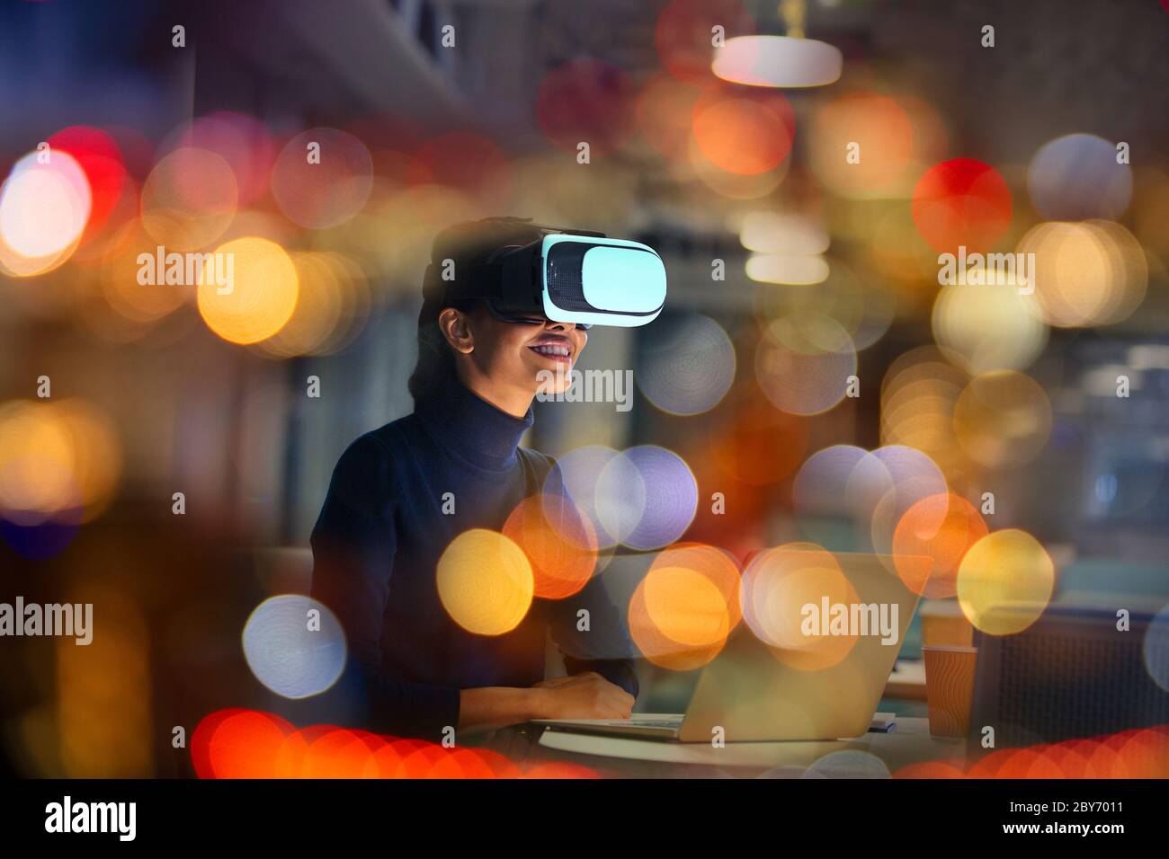 Smiling businesswoman using virtual reality glasses Stock Photo