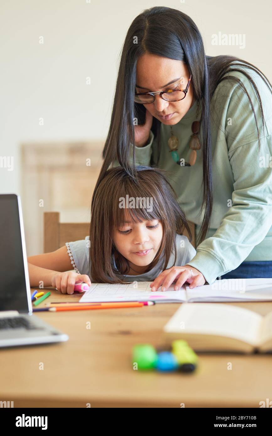 Mother helping daughter with homework Stock Photo