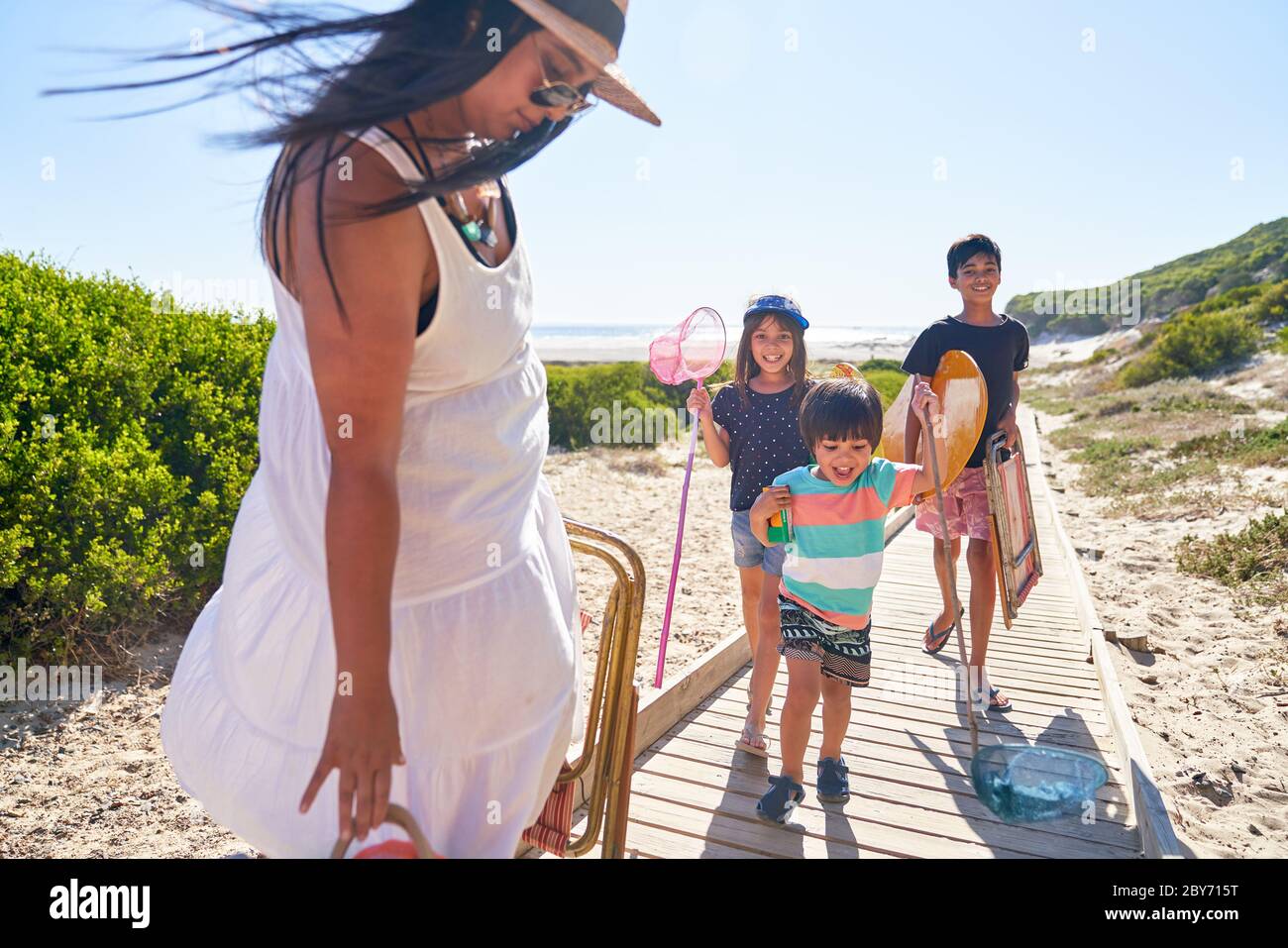 Happy family on sunny beach boardwalk Stock Photo